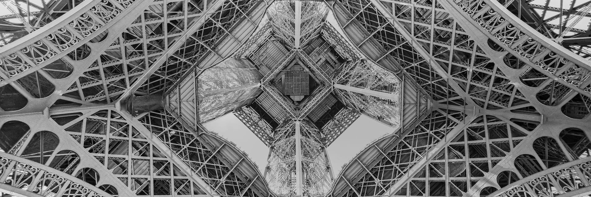 Eiffel Tower in Paris seen from below in illustration of the heritage of French know-how and innovation - History of the EuroCave factory in northern France Eiffel Tower in Paris seen from below in illustration of the heritage of French know-how and innovation - History of the EuroCave factory in northern France