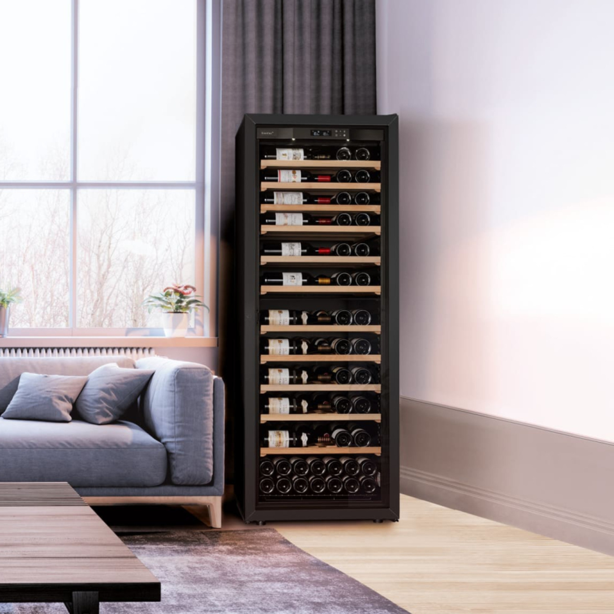 Large wine cabinet with glass door and free-standing black frame in a living room next to the sofa - La Première EuroCave