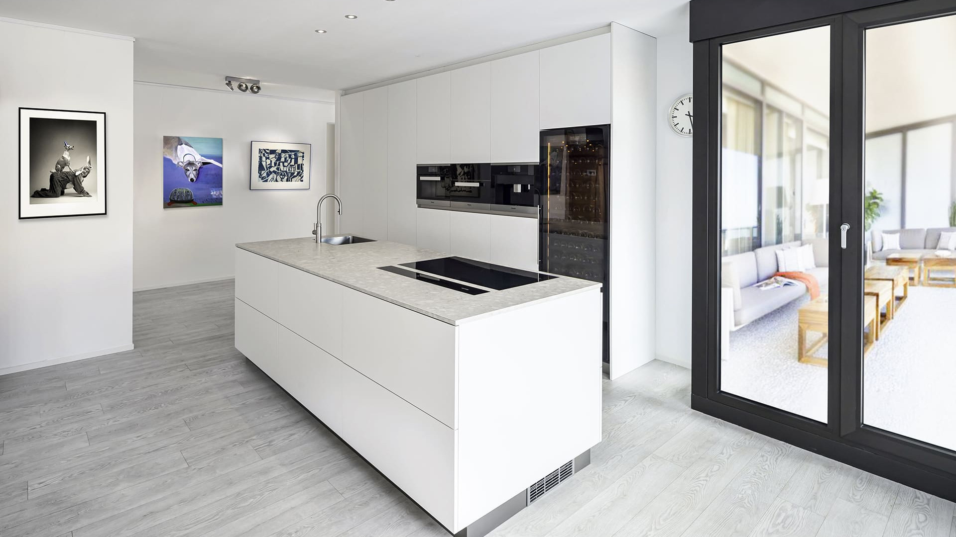 Example of a built-in free-standing wine cabinet in a kitchen with a white and black color scheme in a luxury apartment. EuroCave Revelation