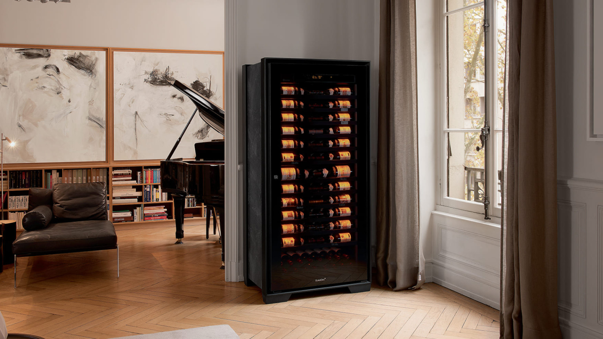 Royale aging wine cabinet installed in a musician’s living room; in the background a grand piano and paintings. – EuroCave