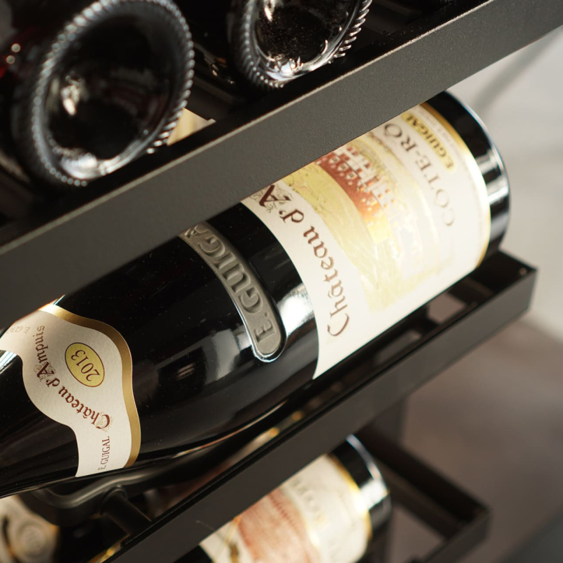Overhead wine storage with several types of shelves that offer several storage and presentation possibilities.