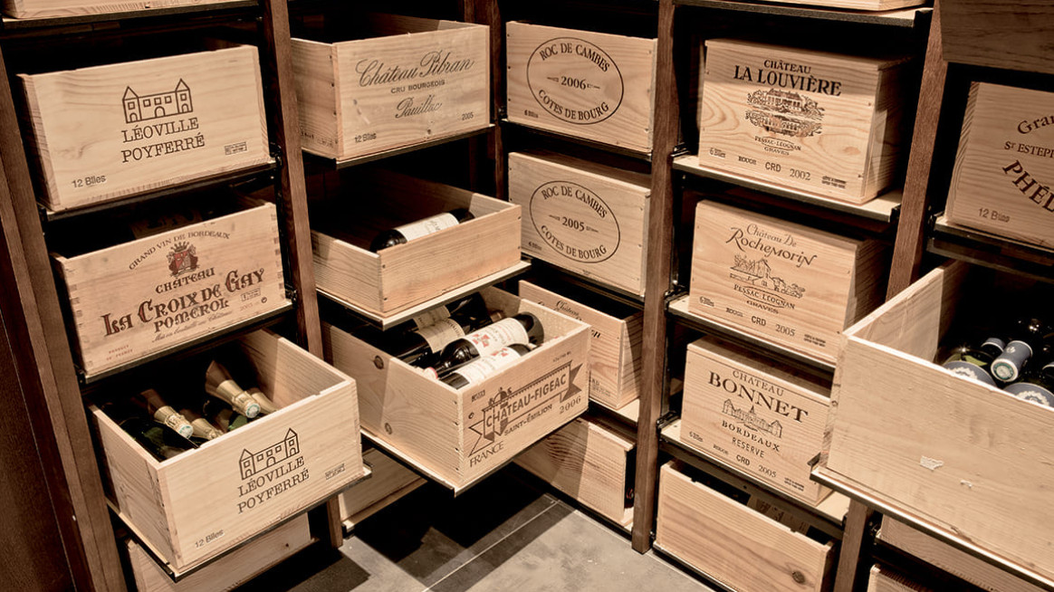 Modular wine storage - sliding racks that can be assembled to store wine wood box in a cellar over time to age the wine.