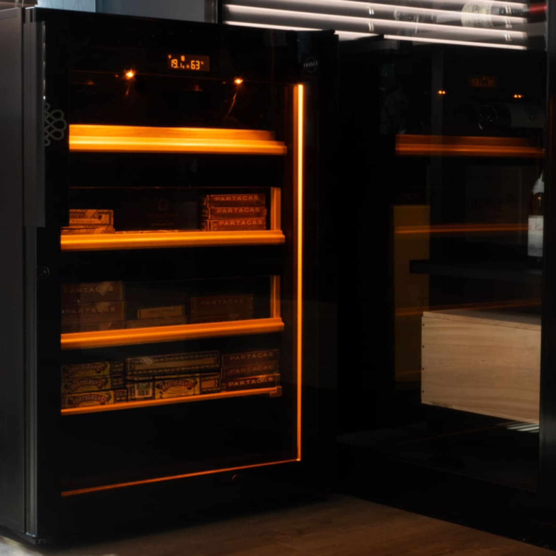 Cigar humidor cabinet with integrated amber light: lighting from above and light strip all around the humidor.