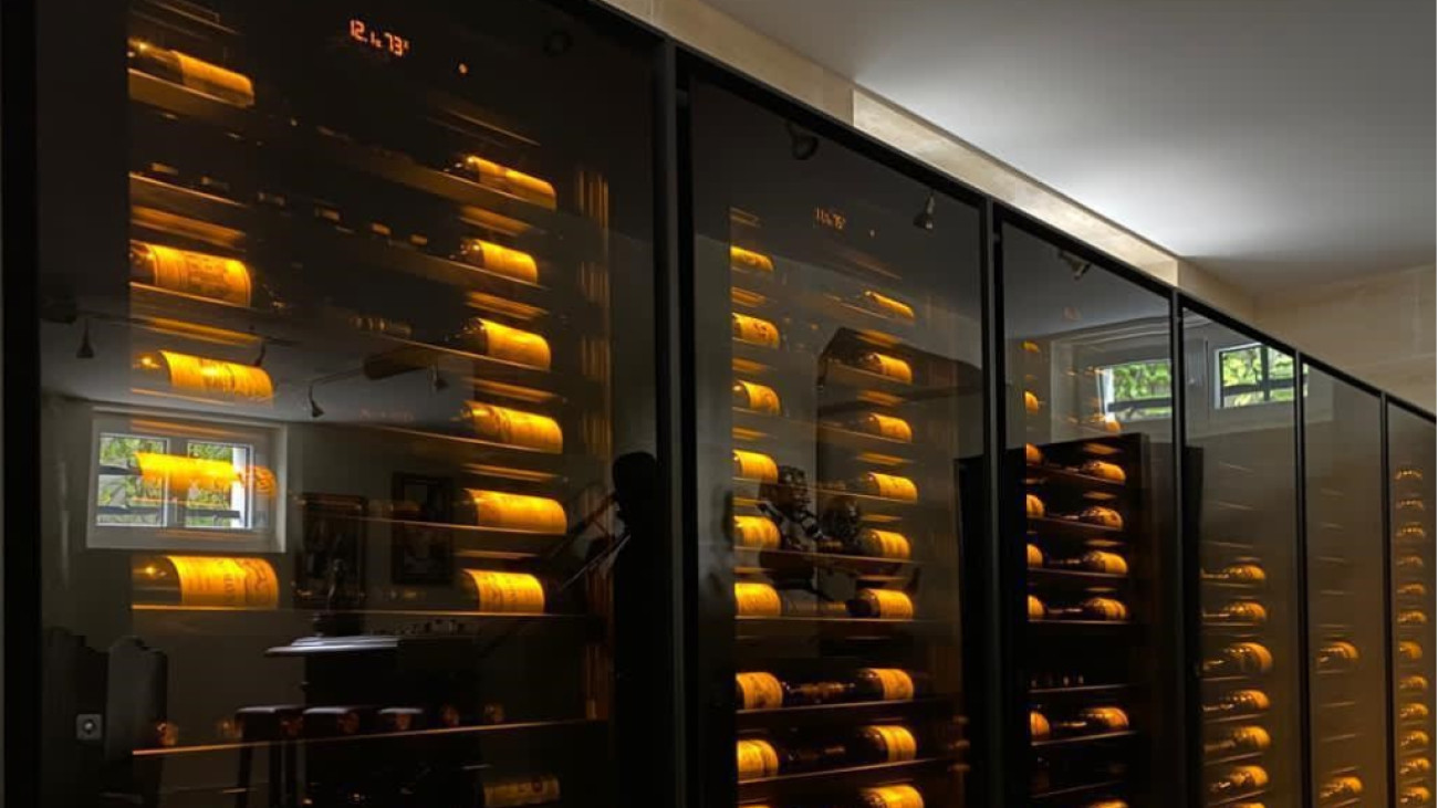 Wall of luxury wine cabinets with beautiful bottle lighting which allows you to clearly see the labels of fine wines and enhance your wine catalog. Wall of luxury wine cabinets with beautiful bottle lighting which allows you to clearly see the labels of fine wines and enhance your wine catalog.