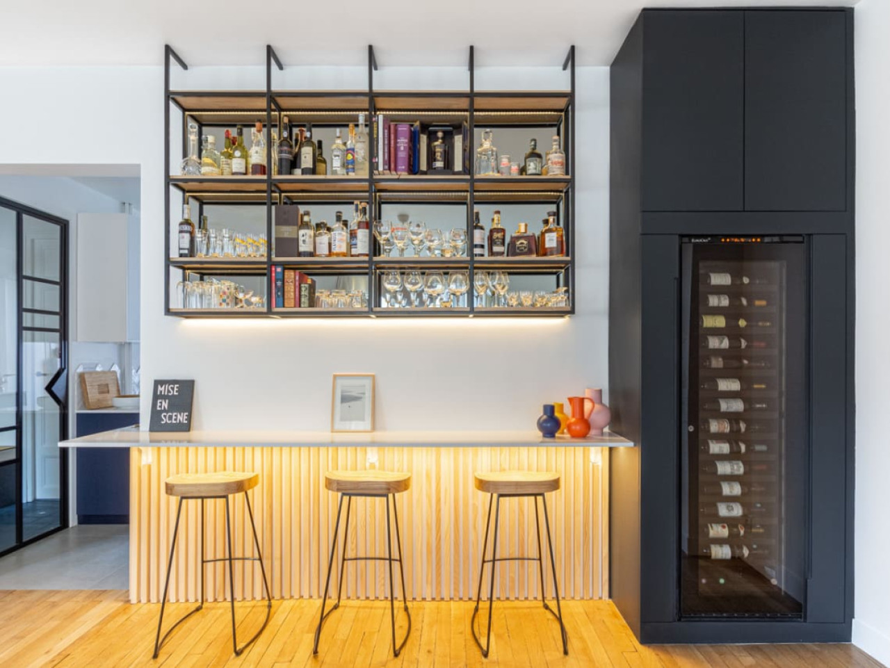 Living room bar with a eurocave wine cooler integrated into a piece of furniture