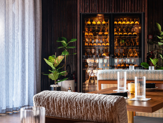 ShowCave wine display cabinet in a Dubai restaurant, built into a wood-effect wall