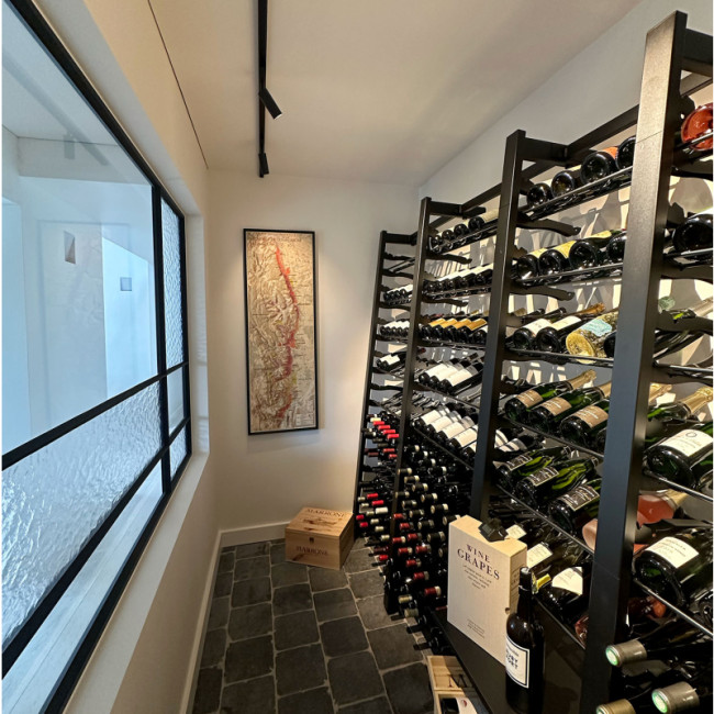 Set of sturdy modular metal shelves to create a wine cellar with a large capacity for storage and bottle storage.